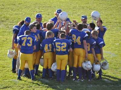 The Lansing Bobcat coaches and players celebrate their first win of the 2011 football season with a 26-12 victory against the Homer Trojans. Photo by Michelle Eastman sff Victory
