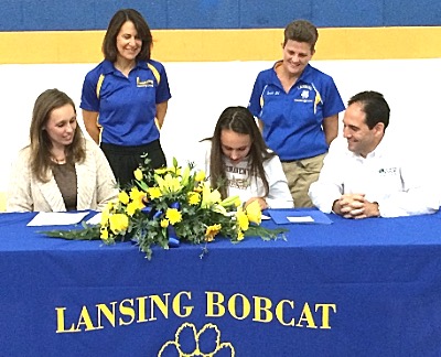 Adele Ferris signs to swim for St. Bonaventure University s parents Melissa and Jamie, Coach Diane Hicks-Hughes (right) and Assistant Coach Shelly Matheny look on adelesigning2