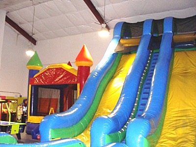 The big play room has a giant slide that, when deflated and folded up, weighs 800 pounds, plus two bounce houses. Those are rotated with other inflatables throughout the year. jump slide