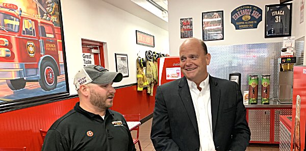 A painting on the wall depicts the Ithaca Fire Department Firehouse Subs