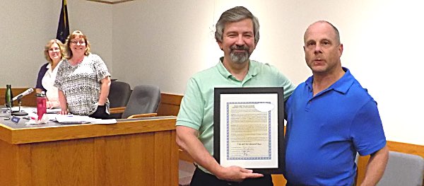 Jeffrey Boles (right) was presented a framed copy of a resolution to rename a town ball field after him by Lansing Town Supervisor Ed LaVigne Jeffrey Boles